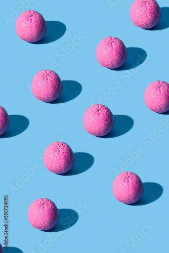 Pink oranges pattern on blue background pastel colors. Minimal style.