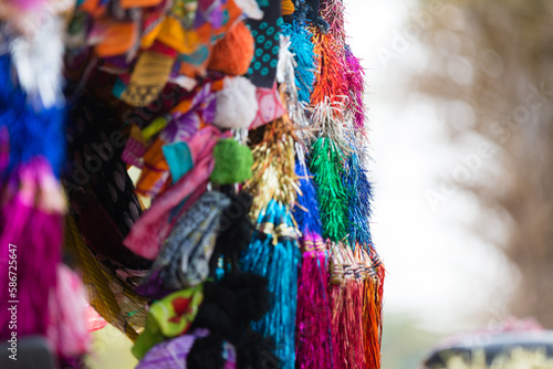 Mass of colorful items, goods and ribbons as deocortaioin and for sale at a stall in India at the market