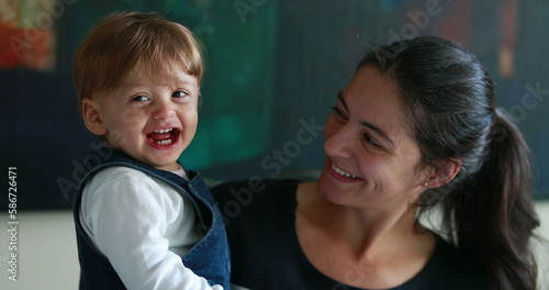 Casual mother and baby together smiling, real life one year old smiling to with mom