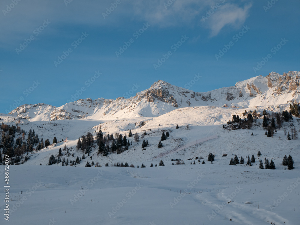 San Pellegrino Pass, Moena, Trentino Alto Adige, Italy: scenic view of snow covered landscape and Dolomites surrounding San Pellegrino mountain pass