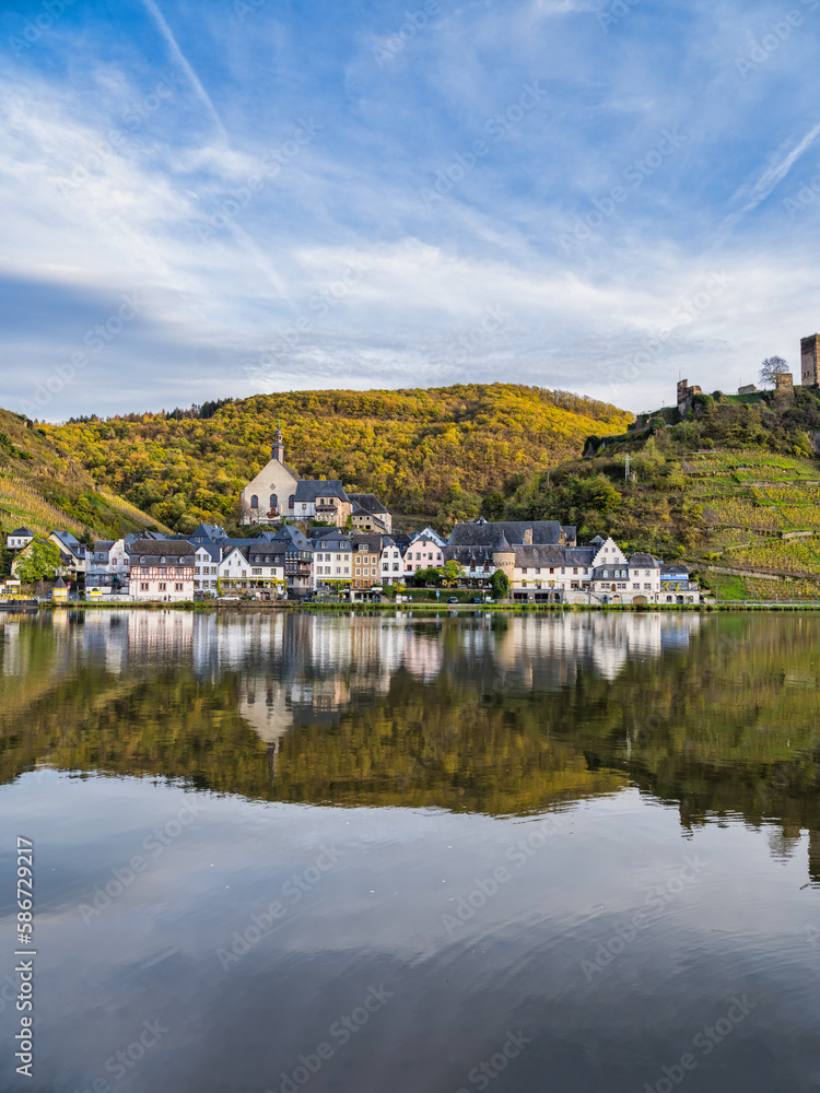 Vertical shot of Beilstein village wiht clear reflection on Moselle river during autumn in Cochem-Zell district, Germany
