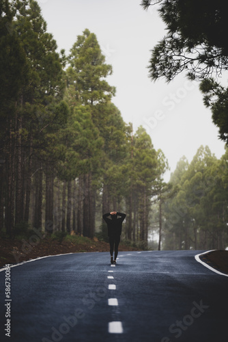 Obraz na płótnie Stunning view of a girl walking on a road that crosses a beautiful forest. Pico de las Nieves, Gran Canaria, Canary Islands. w salonie