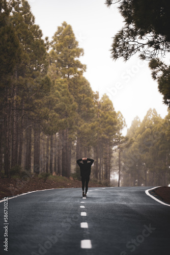 Obraz na płótnie Stunning view of a girl walking on a road that crosses a beautiful forest. Pico de las Nieves, Gran Canaria, Canary Islands. w salonie