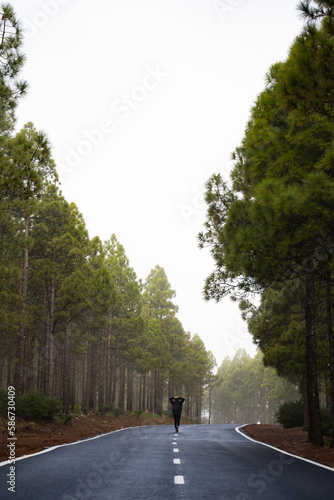 Obraz na płótnie Stunning view of a girl walking on a road that crosses a beautiful forest. Pico de las Nieves, Gran Canaria, Canary Islands. w salonie