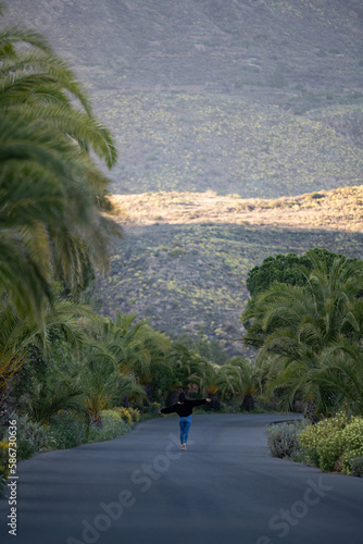 Obraz na płótnie Stunning view of a girl walking on a road that crosses a beautiful forest. Pico de las Nieves, Gran Canaria, Canary Islands. w salonie