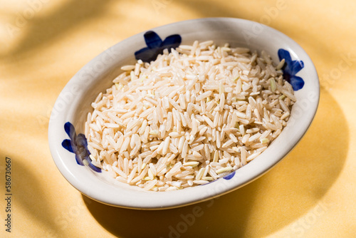 plate with healthy brown rice on the table top view