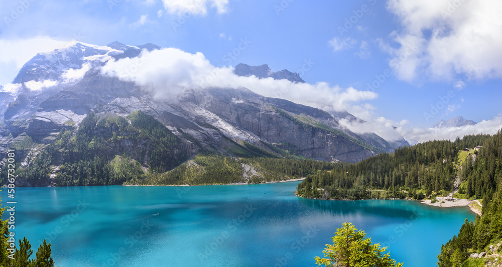 Panorama view of the famous Oeschinensee late summer with alps mountain at the background near Kandersteg