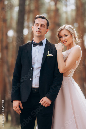 Wedding portrait. Amazing smiling wedding couple. Pretty bride and stylish groom. © VlaDee