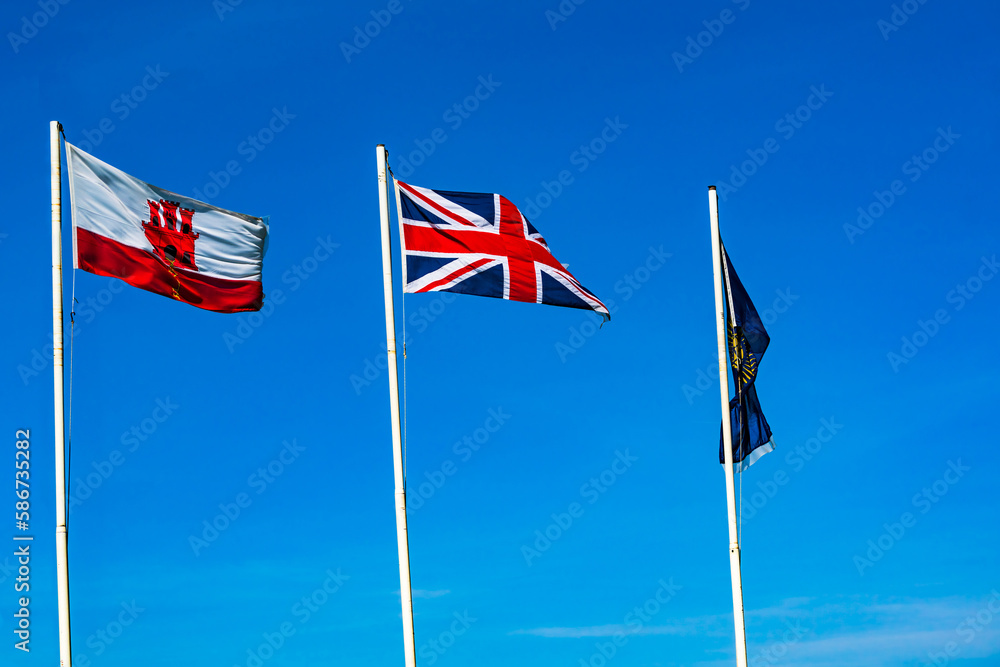 Gibraltar, British and Commonwealth Flags against blue sky