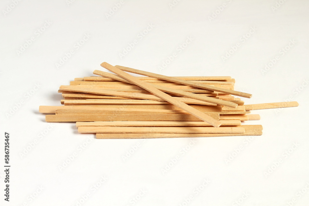 wooden stick stirrers for cofee,tea,drinks isolated on white background,copy space selective focus wooden stick stirrers for cofee,tea,drinks isolated on white background,copy space selective focus