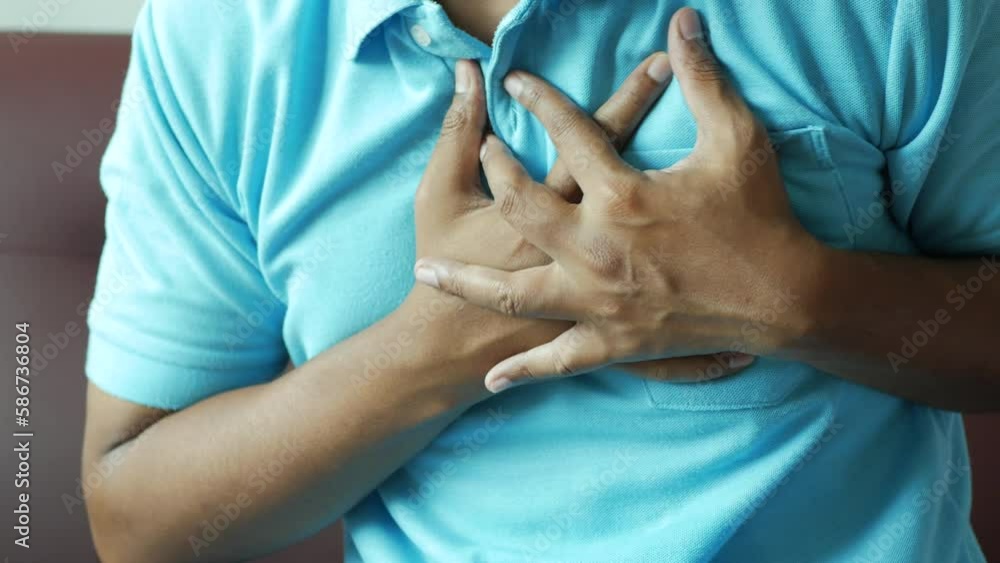 young man suffering pain in heart and holding chest with hand young man suffering pain in heart and holding chest with hand