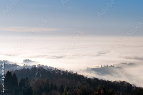 Morning fog in the countryside. Beautiful landscape view over the forest. 
