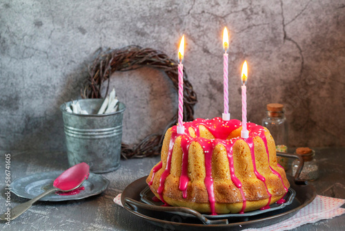 Orange vanilla cake covered with pink icing, Easter decor.