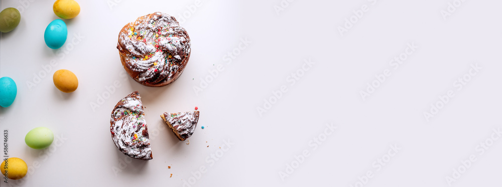 Banner of Easter Kraffin on light background with colored eggs. Cake with raisins, chocolate, nuts, Banner of Easter Kraffin on light background with colored eggs. Cake with raisins, chocolate, nuts,