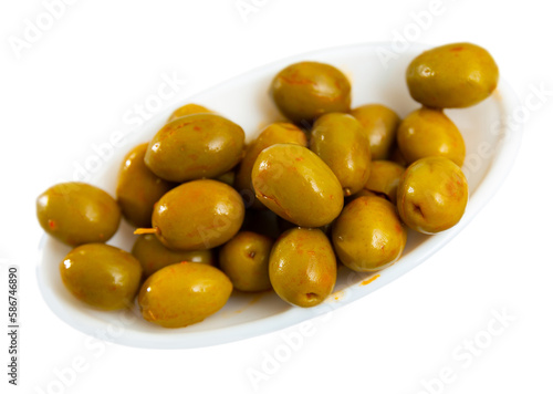 Bowl filled with pickled green olives with bones, popular healthy snack. Isolated over white background