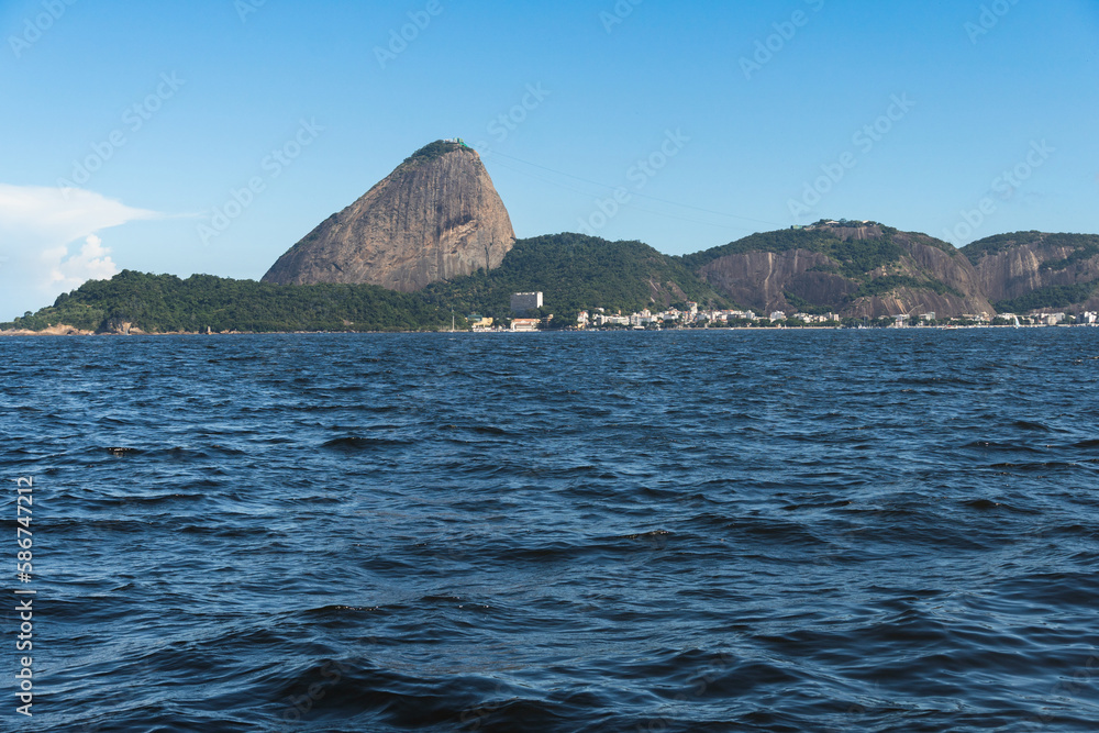Guanabara Bay in Rio de Janeiro, Brazil with Sugarloaf Mountain in the background. Beautiful landscape and hill with the sea. Sunny summer day