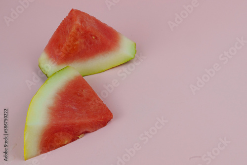 Photo of Two watermelon slices on pink background