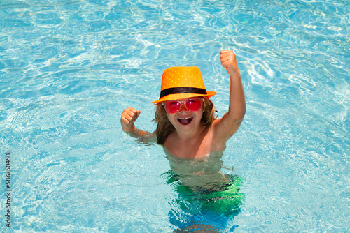 Excited kid boy in pool. Child swimming in water pool. Summer kids activity  watersports.