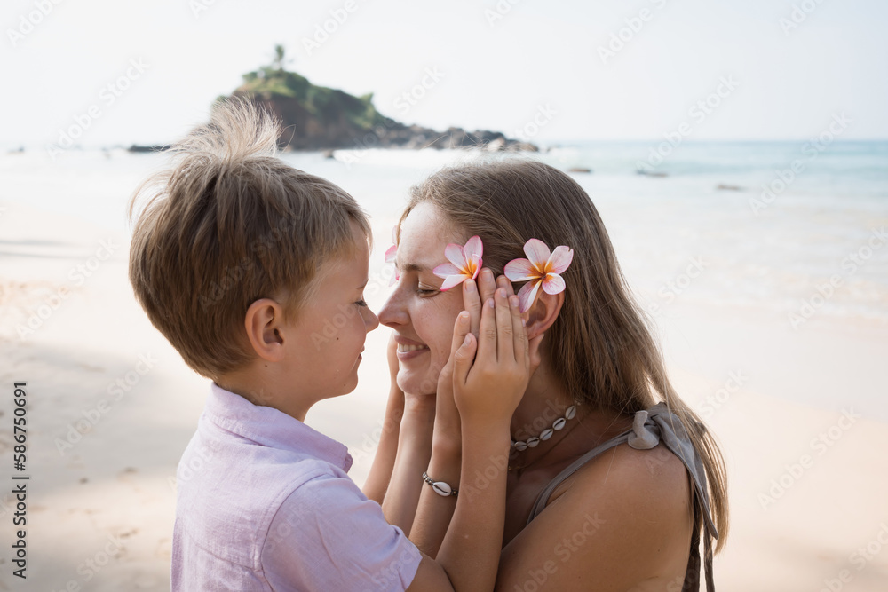 Happy mother and son at the beach in summer Happy mother and son at the beach in summer