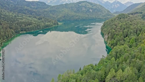 A stunning aerial view captures the picturesque Alpsee lake, located near the iconic Neuschwanstein castle.