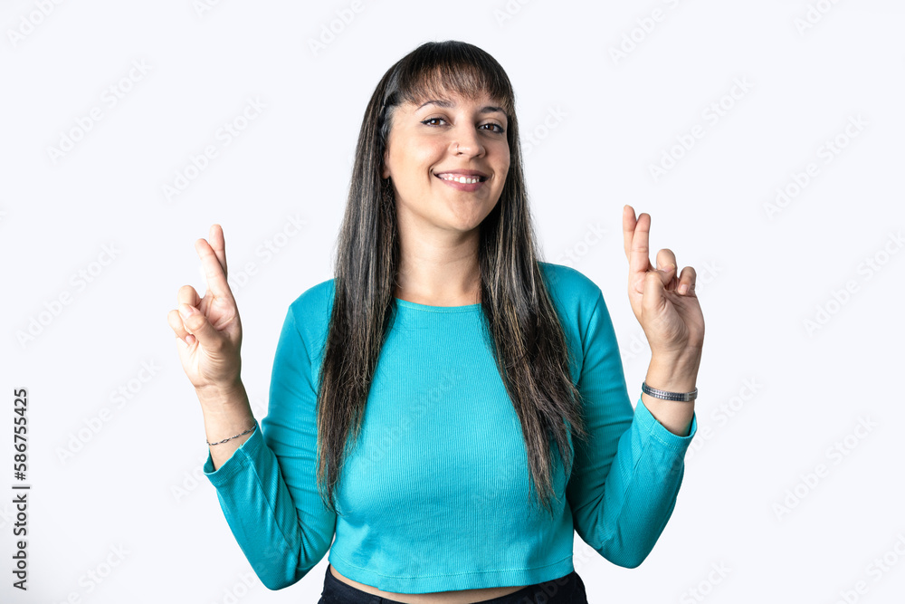 Pretty girl with her fingers crossing over white background. Happy woman with fingers crossing. Pretty girl with her fingers crossing over white background. Happy woman with fingers crossing.