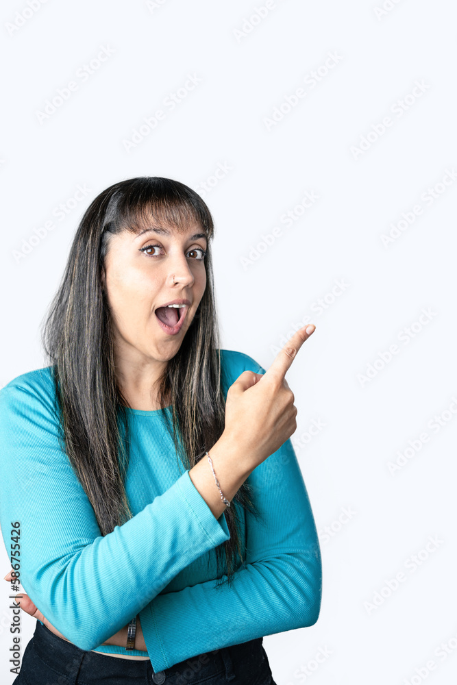 Surprised woman pointing to the side on a white background. Surprised woman pointing to the side on a white background.