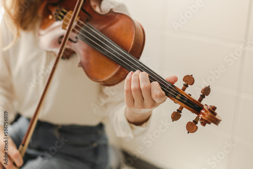 Young Woman Playing Classical Instrument Violin or Bluegrass Fiddle