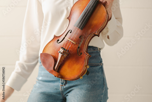 Female Hands Holding Beautiful ViolinFiddle, an Orchestra or Bluegrass Instrument