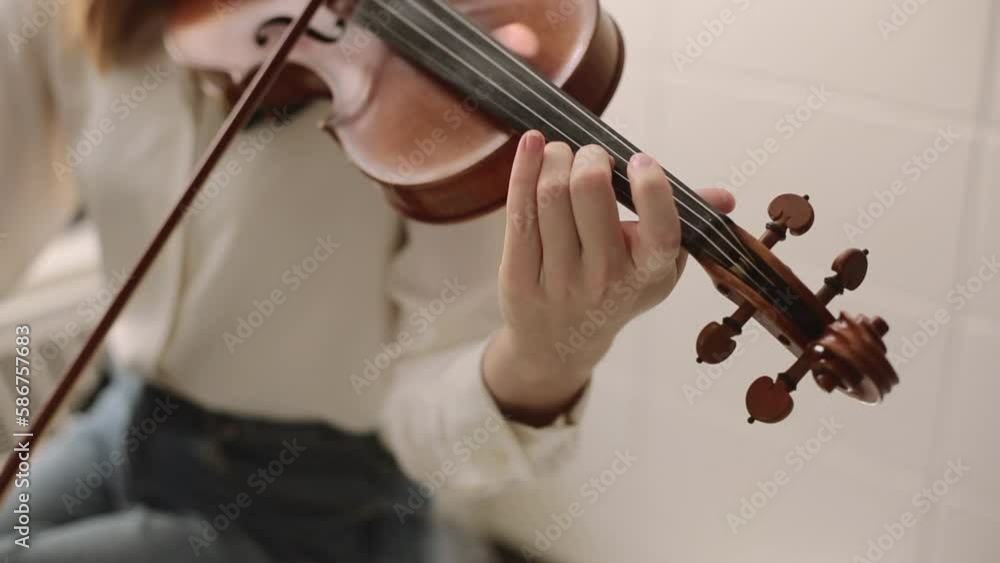 Young Woman's Fingers Playing Violin at Home for Practice, Classical, Bluegrass, or Celtic Instrument Young Woman's Fingers Playing Violin at Home for Practice, Classical, Bluegrass, or Celtic Instrument