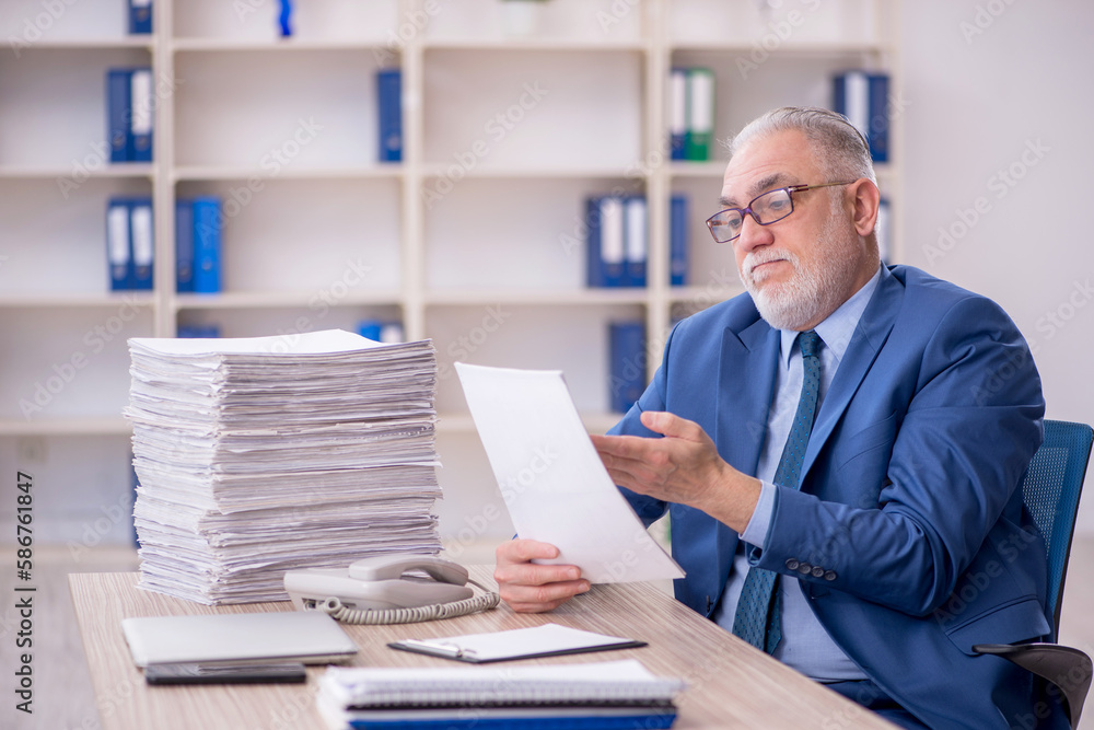 Old male employee and too much work in the office Old male employee and too much work in the office