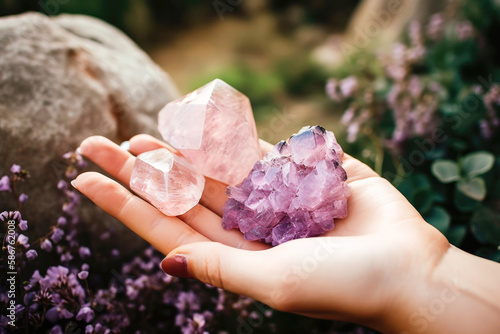 Closeup of woman holding pink amethyst crystals in her hand outdoors. Generative AI. 