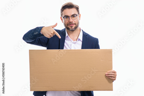 Man in studio showing promo blank board pointing finger on sign board. Blank signboard with copyspace. Advertisement concept. Ad board with copy space, blank mockup. Blank signboard, placard.