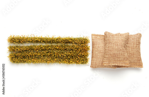 A picture of miniature rice paddy field and rice bags on white background