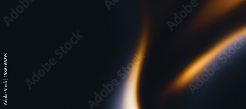 Golden flame on black grainy textured background, abstract blurred orange waves on dark noise texture, copy space