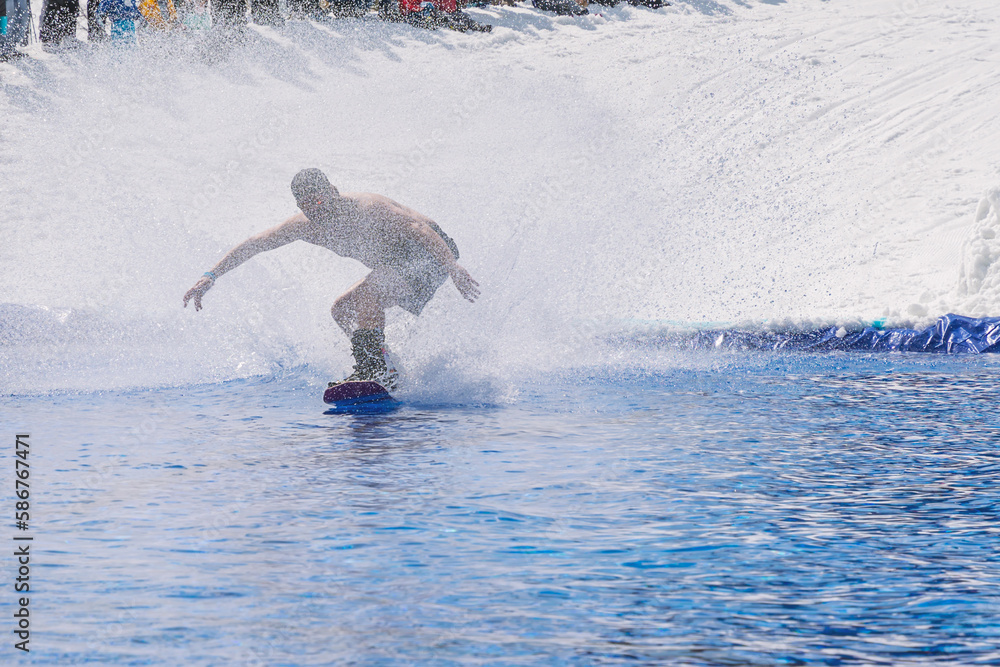 Fototapeta premium People are enjoying Pond skim at the end of ski season