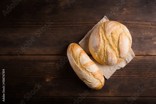 loaf of bread on wooden table  two freshly baked loaves  freshly baked bread on a wooden table