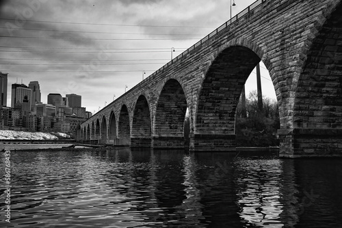 Arch bridge in Minneapolis.   Picture in black and white.