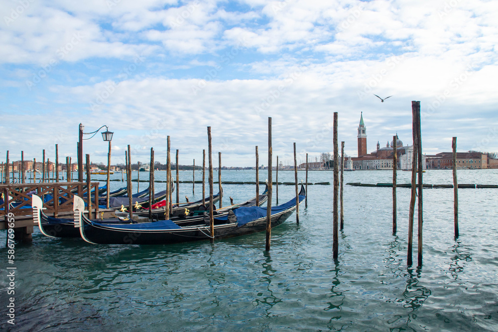 Gondolas in San Marco basin, view at San Giorgio Maggiore island. Venice, Italy.