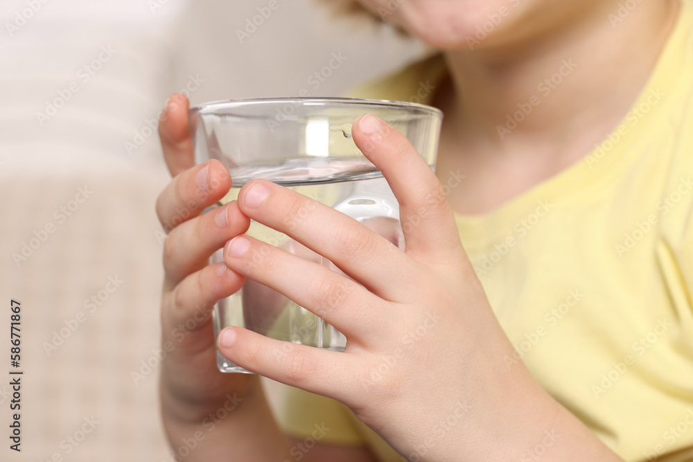 Little boy holding glass of fresh water, closeup Little boy holding glass of fresh water, closeup