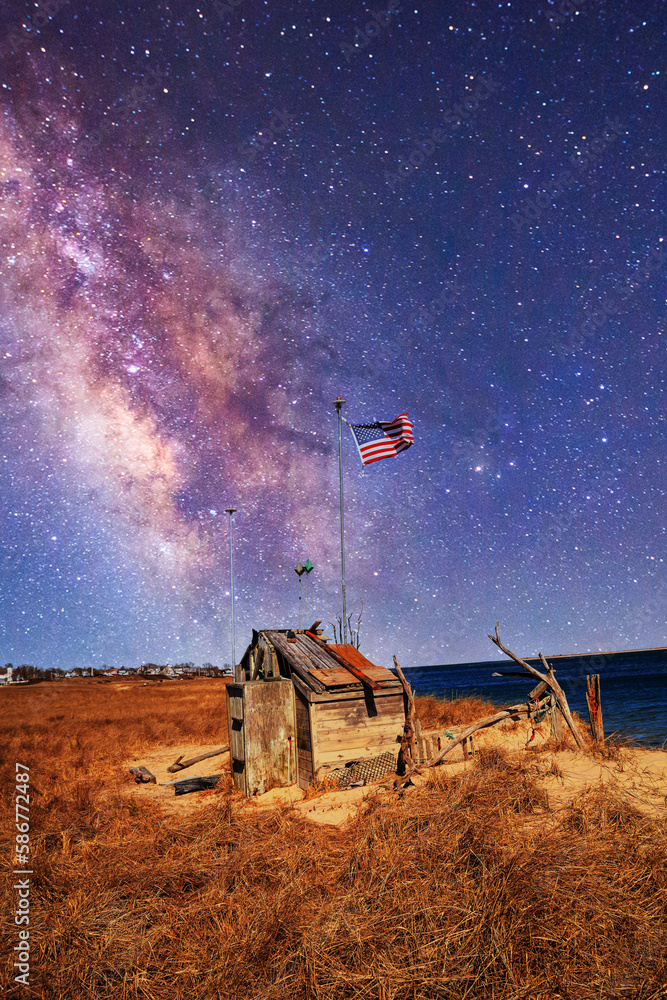 Fototapeta premium Night sky over the Occupy Chatham public shack on Chatham South Beach