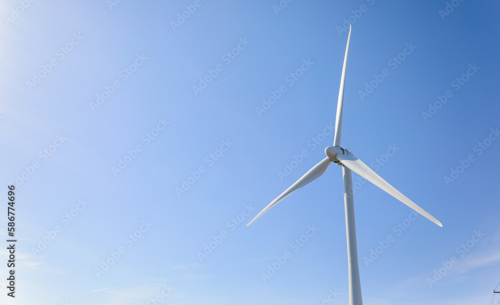 wind turbine standing tall against a clear blue sky, symbolizing sustainability, renewable energy, and the use of alternative energy resources in industry wind turbine standing tall against a clear blue sky, symbolizing sustainability, renewable energy, and the use of alternative energy resources in industry