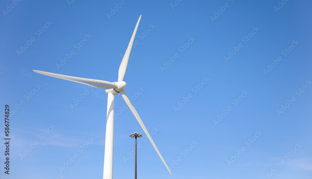 wind turbine standing tall against a clear blue sky, symbolizing sustainability, renewable energy, and the use of alternative energy resources in industry wind turbine standing tall against a clear blue sky, symbolizing sustainability, renewable energy, and the use of alternative energy resources in industry
