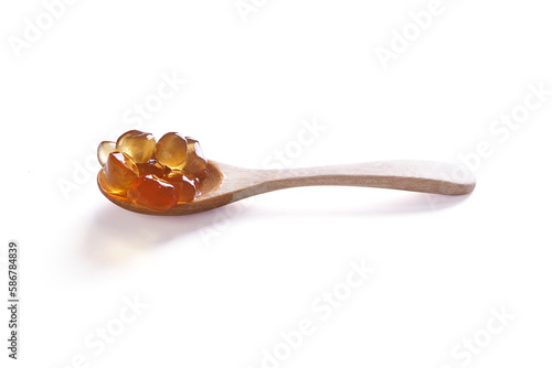Tapioca Pearls (Bubble Tea) on wooden spoon isolated on white background, It's small chewy balls made from tapioca starch, Commonly used as a topping in milk tea drinks.