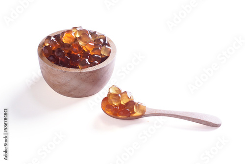Tapioca Pearls (Bubble Tea) on wooden spoon and bowl isolated on white background, It's small chewy balls made from tapioca starch, Commonly used as a topping in milk tea drinks.