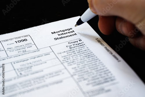 1098 Tax form, Mortgage Interest Statement, IRS document. Pen hand writing close-up