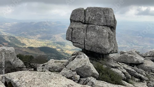 Touring mountainous karstic landscape in the Torcal de Antequera with rocky silhouettes with a fine mist.