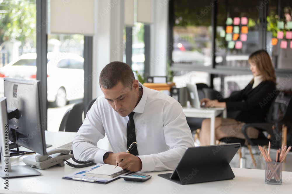 Asian business people sit and look at graphs meeting new projects at the office. Asian business people sit and look at graphs meeting new projects at the office.