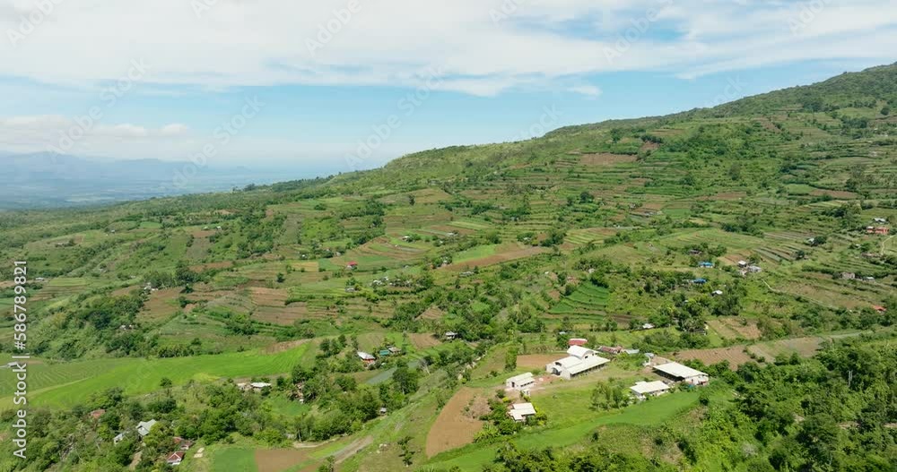 Aerial view of valley in the mountains with farmland and fields of farmers. Negros, Philippines Aerial view of valley in the mountains with farmland and fields of farmers. Negros, Philippines