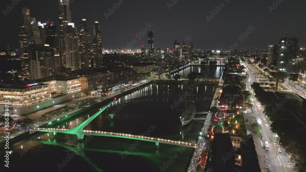 Puerto Madero Buenos Aires at Night, Aerial Drone Fly Above Waterfront Dock and Woman's Bridge, Skyscrapers, Nighttime Establishing Shot Puerto Madero Buenos Aires at Night, Aerial Drone Fly Above Waterfront Dock and Woman's Bridge, Skyscrapers, Nighttime Establishing Shot