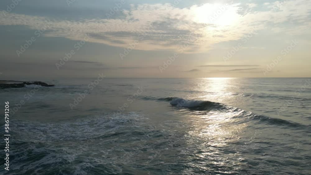 Flying outwards over the Indian Ocean and turning back to reveal the beach and shore Flying outwards over the Indian Ocean and turning back to reveal the beach and shore